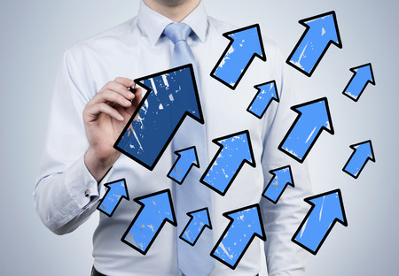 businessman drawing many blue arrowsの写真素材