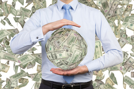 businessman holding money ball on a white backgroundの写真素材