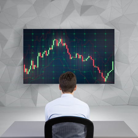 businessman looking on stock chart on screen