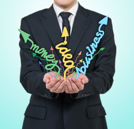 businessman holding arrows on a blue backgroundの写真素材