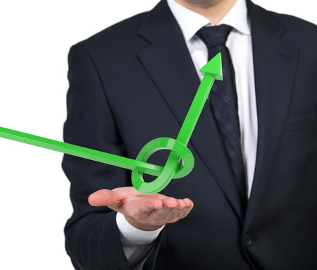 businessman holding green arrow tied in a knotの写真素材