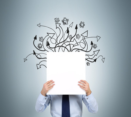 businessman holding poster with drawing arrowsの写真素材