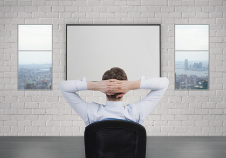 businessman sitting and looking to blank deskの写真素材