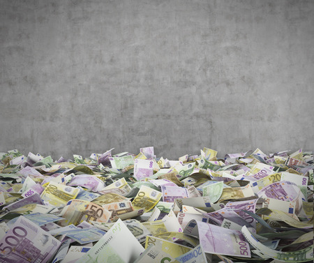 euro banknotes on a conctere wall backgroundの写真素材