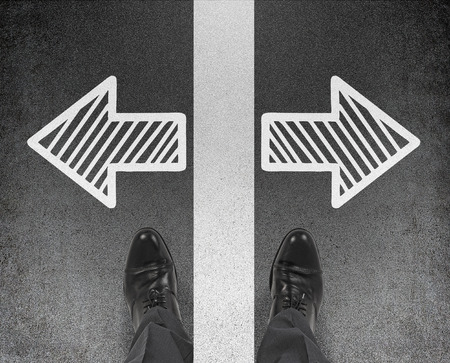 pair of foot standing on a floor with two arrowsの写真素材