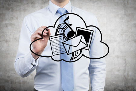 businessman with pen drawing cloud with social media iconsの写真素材