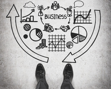 businessman standing on business symbol and chartsの写真素材