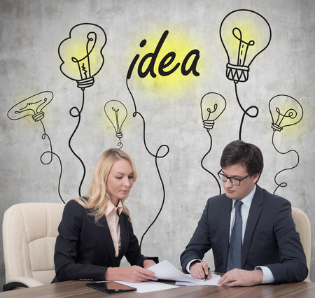 two businesspeople working at meeting in officeの写真素材