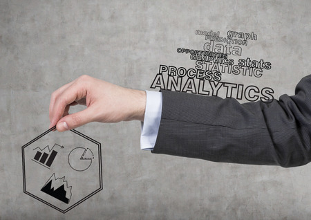 hand holding business icons on a gray backgroundの写真素材