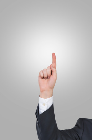 hand pointing finger up on gray backgroundの写真素材