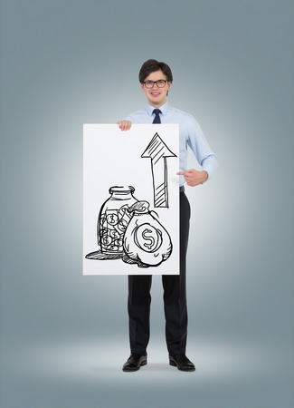 businessman holding placard and drawing money with arrowの写真素材