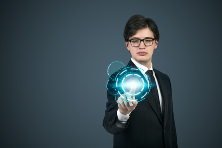 businessman pushing interface on gray backgroundの写真素材
