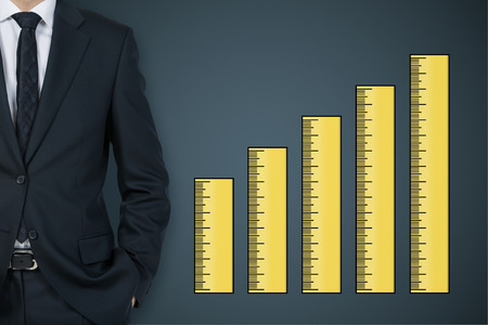 Businessman and drawing a ruler chart on wallの写真素材