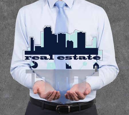 businessman holding drawing real estate symbol in handの写真素材