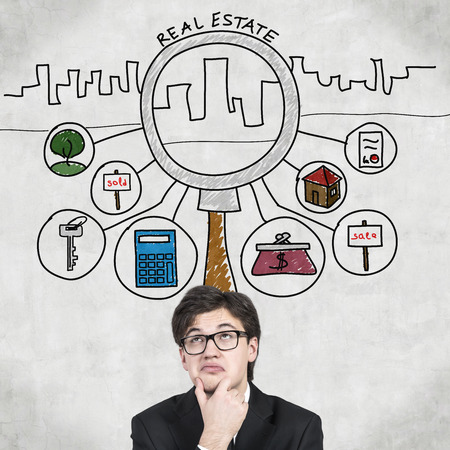 businessman thinking and drawing real estate symbol over headの写真素材