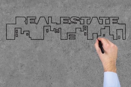 hand drawing real estate text on gray wallの写真素材