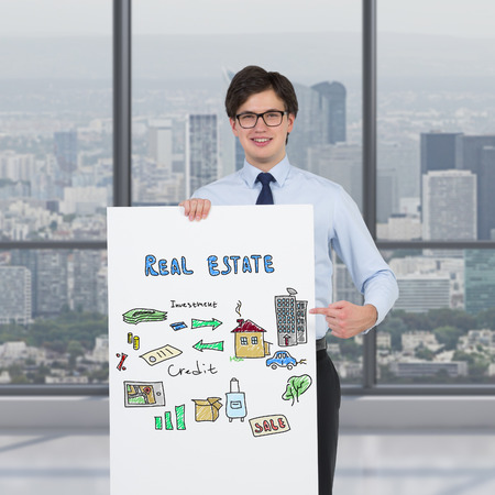 businessman holding poster with drawing real estate conceptの写真素材