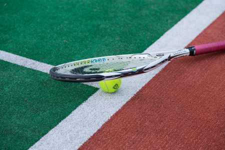 ball and racket on tennis court