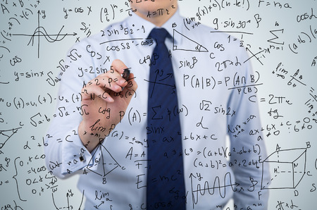 young businessman drawing mathematics equations and formulas
