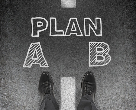 leg businessman standing on drawing plan A and B, choice conceptの写真素材
