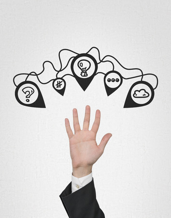 hand with brainstorming icons on a gray backgroundの写真素材