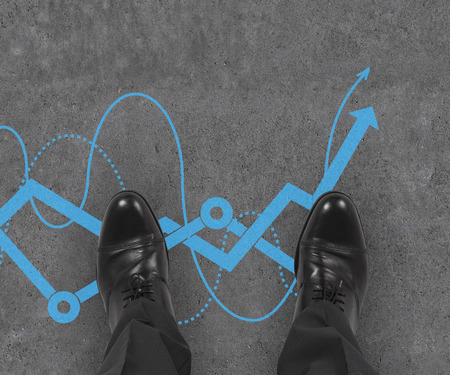 businessman standing on drawing stock chart on floor