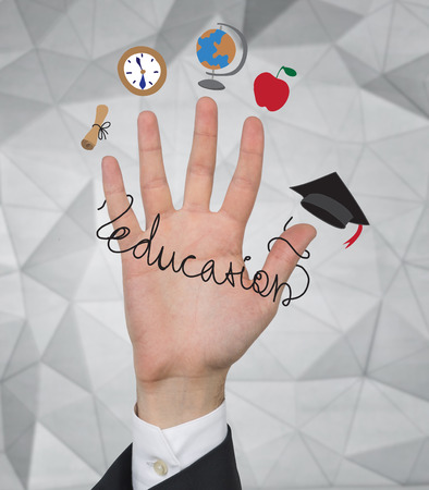 hand with education icons on a gray backgroundの写真素材