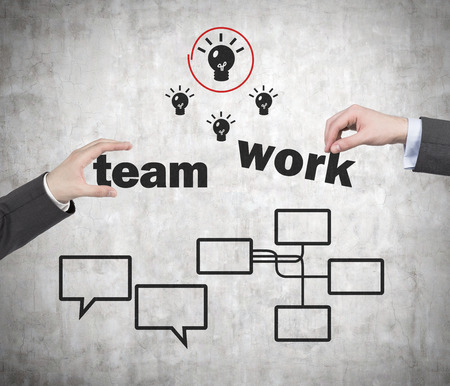 hand holding teamwork symbol on gray wall backgroundの写真素材