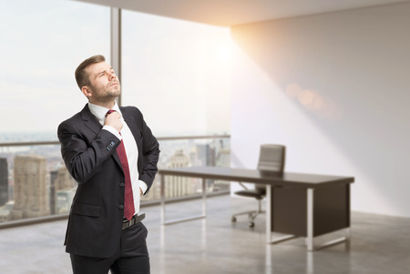 A close up of the person in the office. CEO at the working place in modern panoramic New York office. Consulting services concept.の写真素材