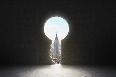 A keyhole in the concrete wall. New York City view in the hole.の写真素材