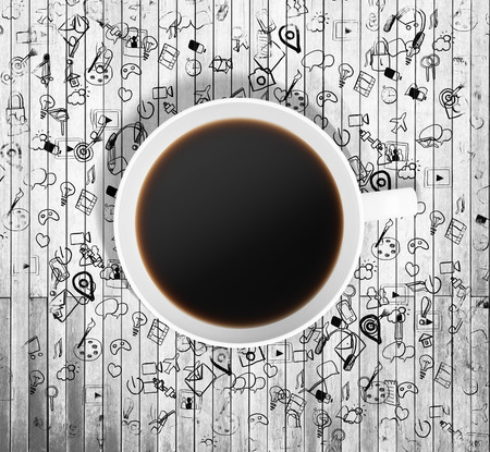 Top view of a cup of coffee and drawn business icons on the wooden table around the cup. 3D rendering.の写真素材