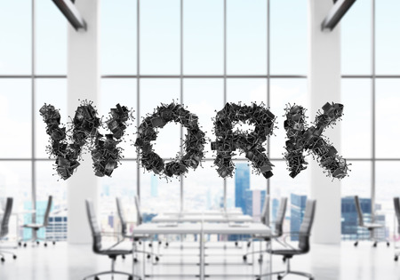 There is a word WORK on the foreground. A modern panoramic office with contemporary workplaces which are on the background in blur. New York panoramic view.の写真素材