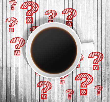 Top view of a cup of coffee and red drawn question marks around it on the wooden table. 3D rendering.の写真素材