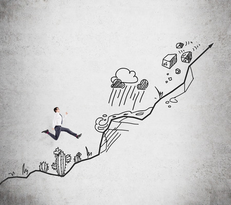 Young businessman climbing up, a picture of a steep path with obstacles such as cactus, mountain, storm, stonefall at the background. Concept of growth.の写真素材