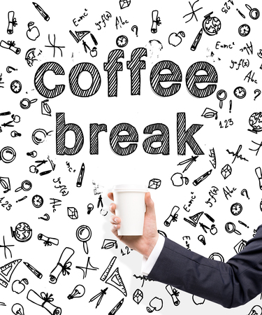 A hand in a black suit holding a paper cup. 'Coffee break' written over it. White background with different scientific symbols. Concept of coffee break.の写真素材