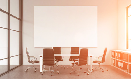 A meeting room for six, chairs arranged around the table, a blank white poster above the table, window to the right, shelves under it. Filter. Concept of negotiations. 3D rendering.の写真素材