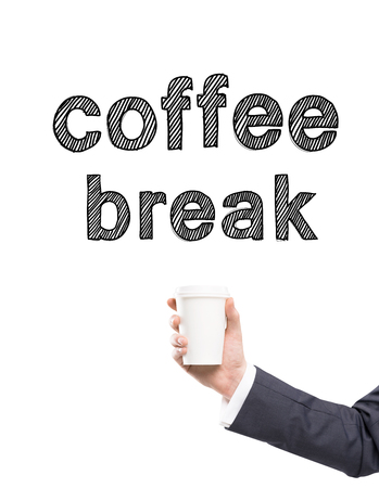 A hand in a suit holding a paper cup, words 'coffee break' written over it. White background. Concept of coffee break.の写真素材