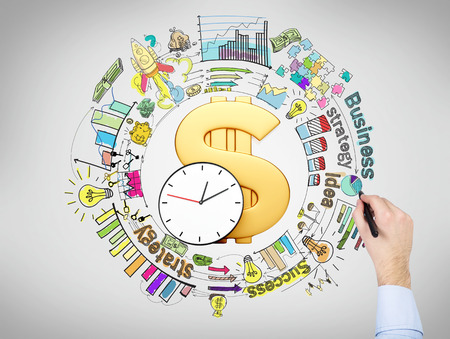 A big golden dollar sign and clock in the center, a hand drawing different coloured graphs and pictures around it, 'business', 'success', 'strategy' written around. Top view. Concept of doing businessの写真素材