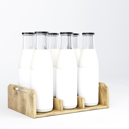 Six glass bottles of milk with black lids in wooden bottle box. Side view. Concept of packing milk. 3D rendering.の写真素材