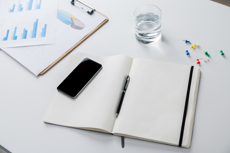 Smartphone on notebook. glass of water aside. Concept of work. 3D renderの写真素材