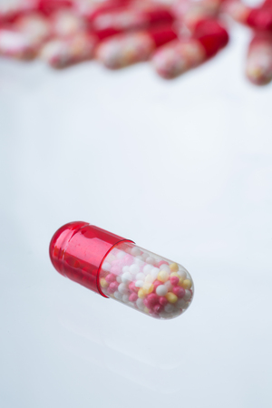 Red pill, many same red pills at background. Close up. Concept of medicine. 3D renderingの写真素材