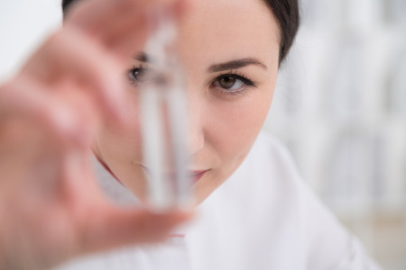 Female doctor holding small ampoule with medicineの写真素材