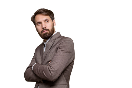 Businessman with crossed arms and beard isolated on white background. Sideview, Mock upの写真素材