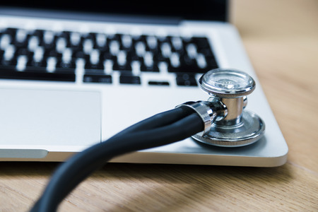 Closeup of stethoscope on notebook keypadの写真素材