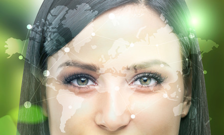 Closeup of woman's face with global networking systemの写真素材