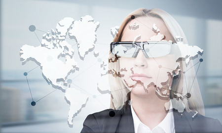 Global network concept with map and businesswoman in smart glassesの写真素材