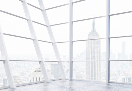 Empty office interior with panoramic framed windows, concrete floor and New York city view. 3D...