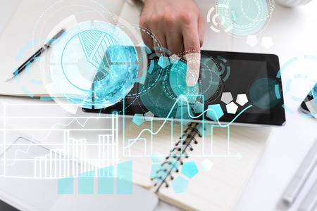Top view of man hand using tablet with circular digital pattern on light desktop with stationery...