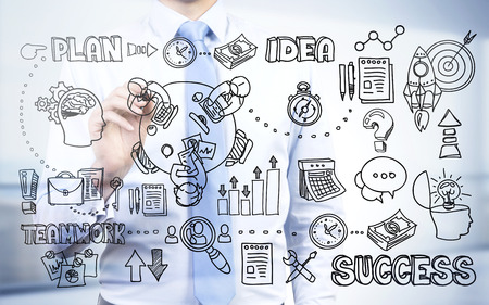 Success concept with businessman drawing abstract business sketch on bright backgroundの写真素材
