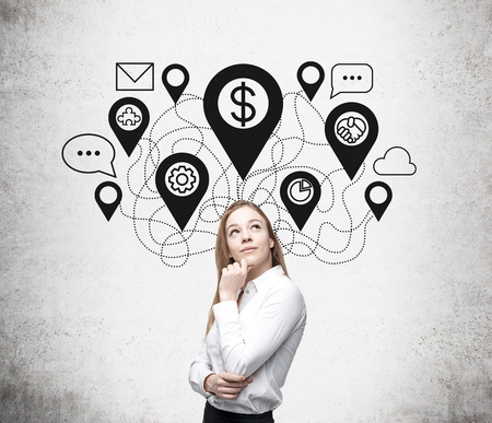 Young business woman thinking about future in front of white wall. Concept of decision making.の写真素材